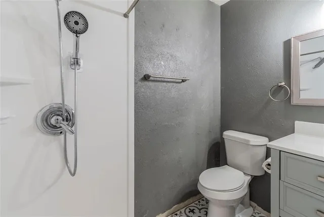 a bathroom with a toilet a shower and a sink