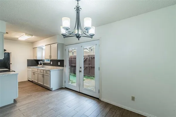 a kitchen with a refrigerator and chandelier