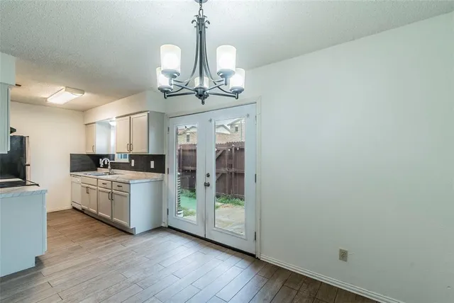 a kitchen with a refrigerator and chandelier