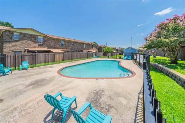 a view of a swimming pool with a patio