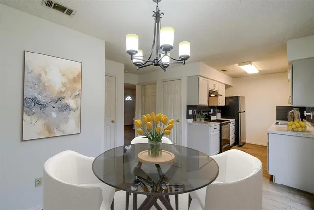 a dining room with furniture and chandelier