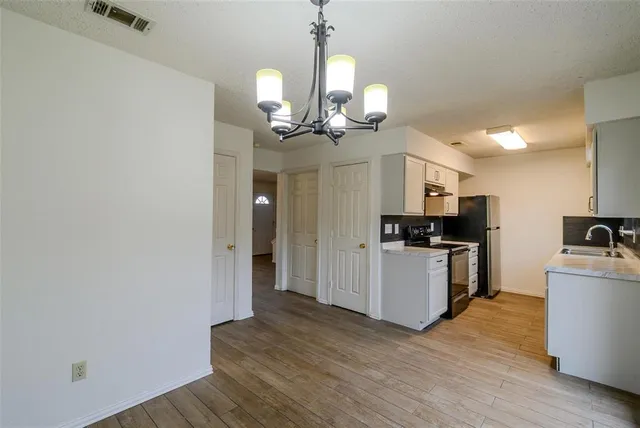 a view of a kitchen with sink and stainless steel appliances