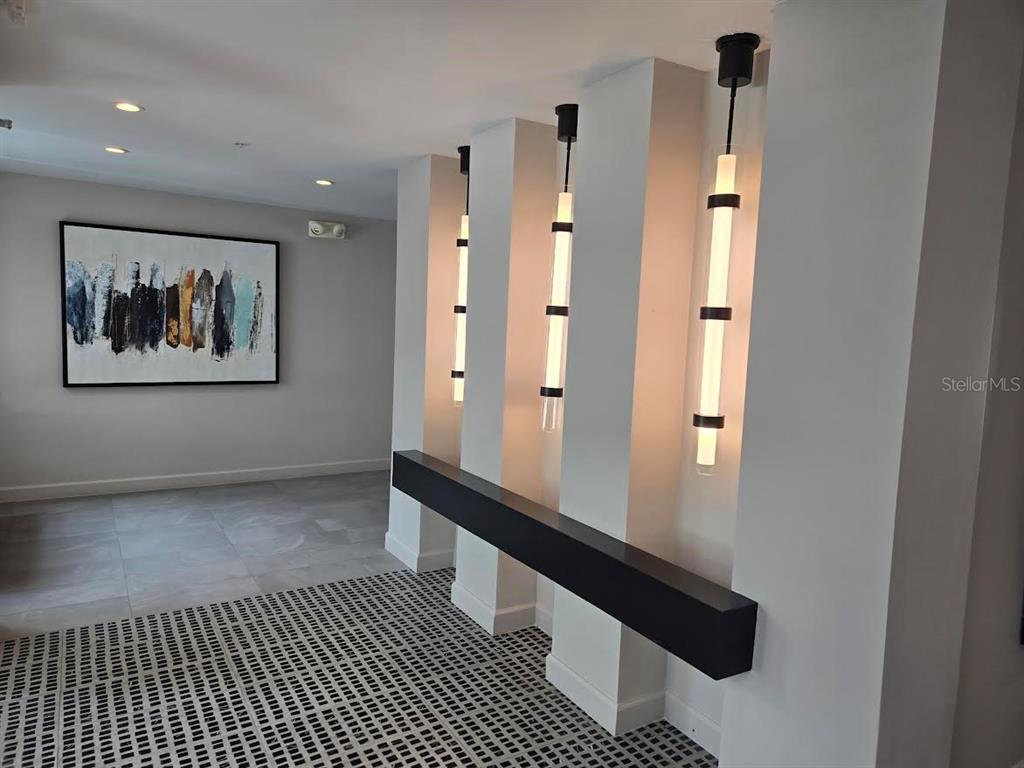 650 Golden Gate Point, Unit 301 Sarasota, FL 34236 - Photo 4 of 31 a view of a hallway with a elevator