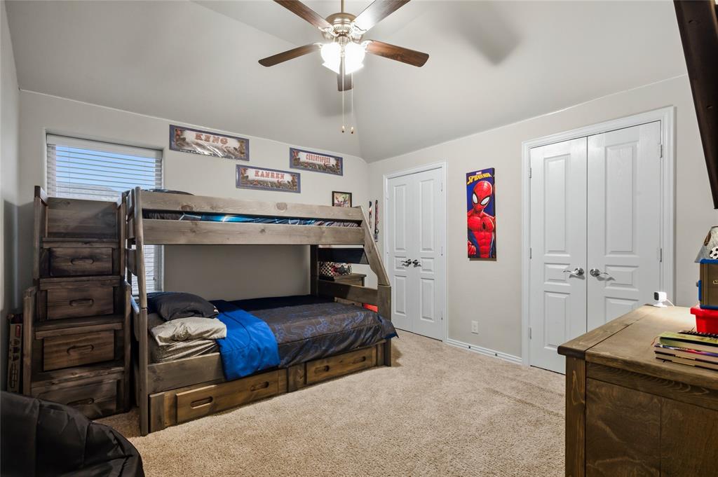 1802 Roundtree Road Forney, TX 75126 - Photo 34 of 39 a bedroom with furniture and a chandelier
