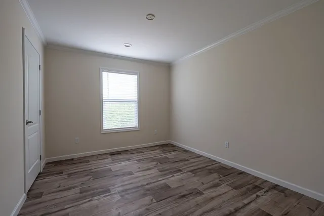 a view of a field with trees in the background