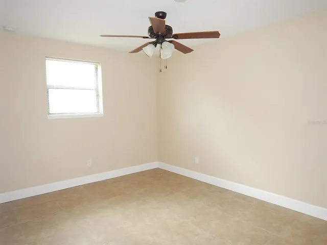 a view of a room with a window and a ceiling fan