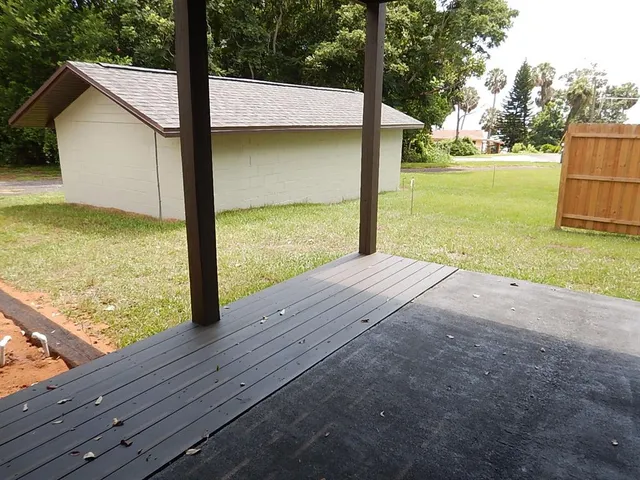a view of a room with wooden floor and fence