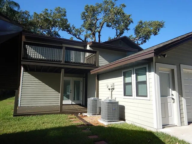 a front view of a house with a garden and plants
