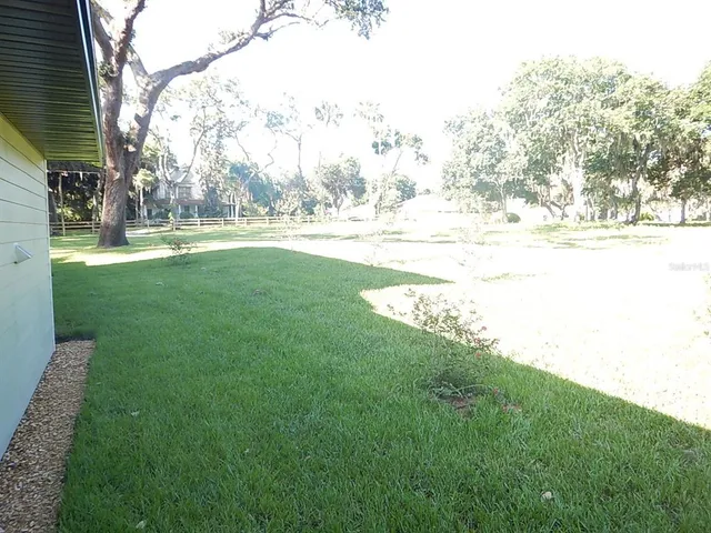 a view of yard with swimming pool and green space
