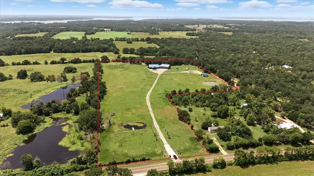 an aerial view of residential houses with outdoor space and city view