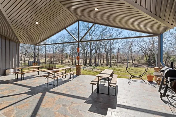 an outdoor sitting area with furniture and wooden deck