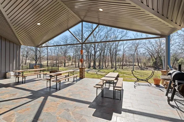 an outdoor sitting area with furniture and wooden deck