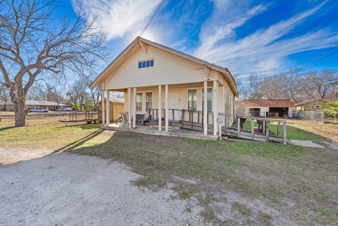 a view of a house with a yard and sitting area