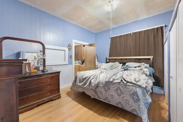 a bedroom with a bed and a mirror