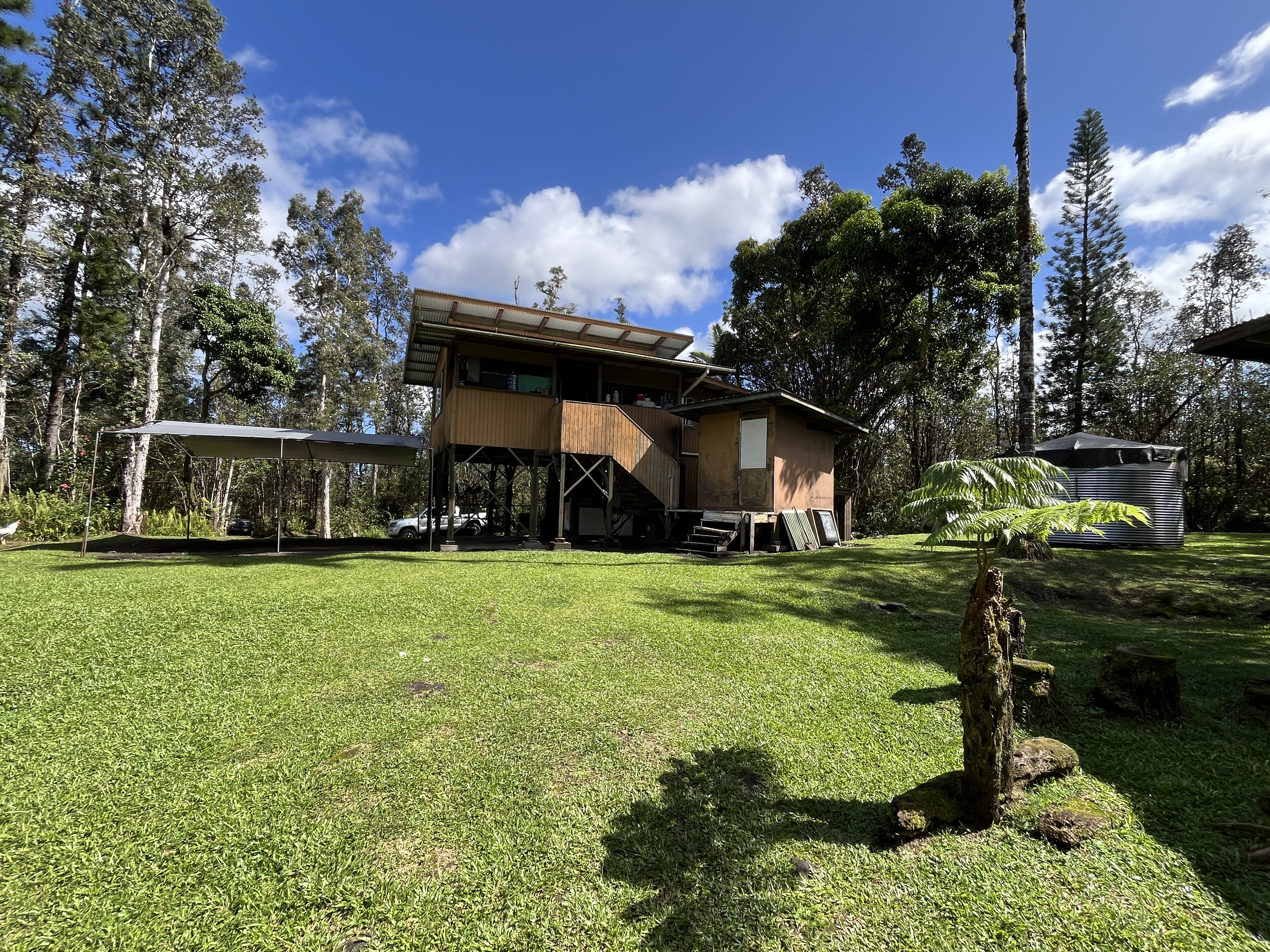16-1088 Opeapea Road Kurtistown, HI 96760 - Photo 13 of 29 a front view of a house with garden