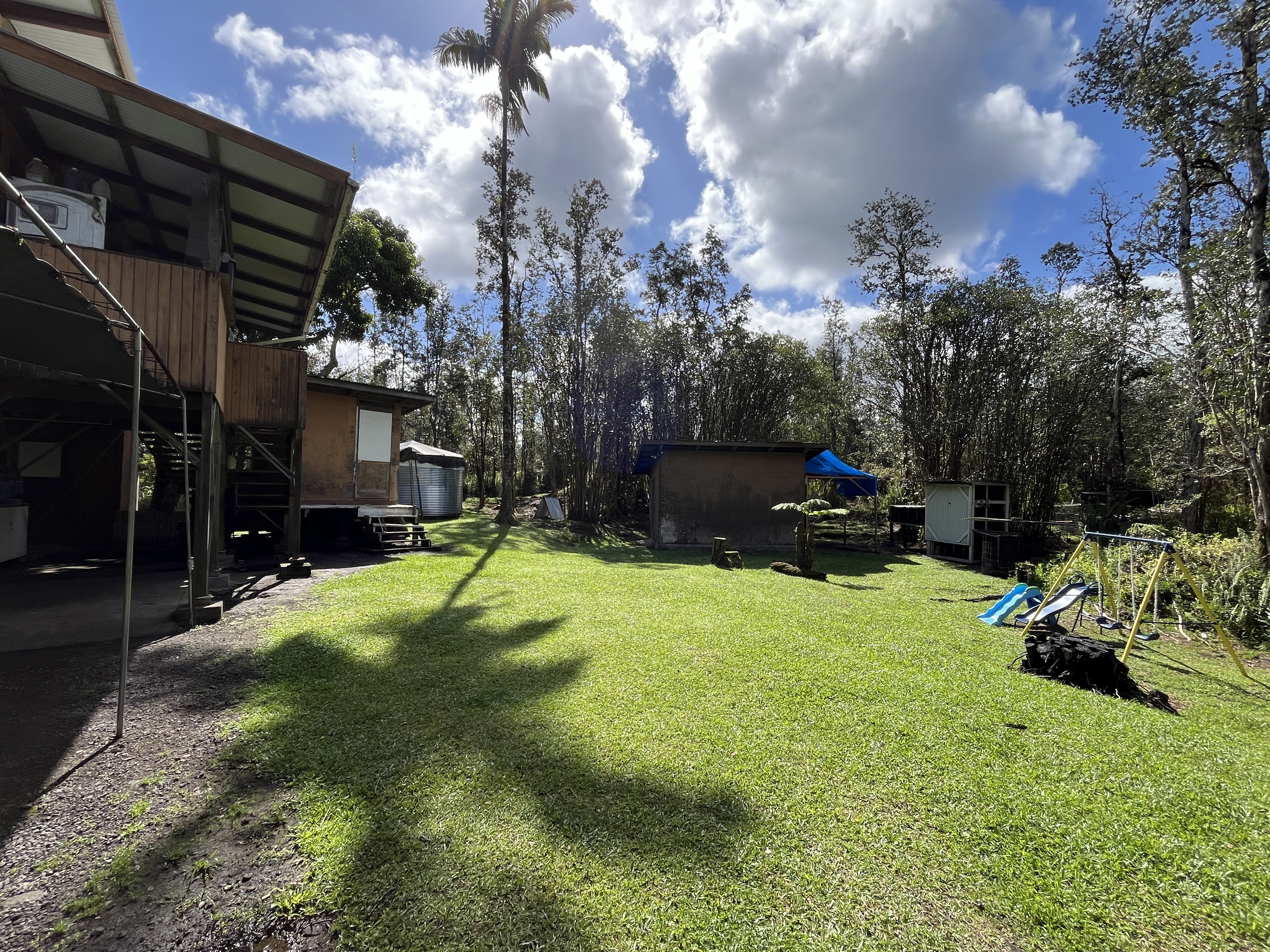 16-1088 Opeapea Road Kurtistown, HI 96760 - Photo 15 of 29 a backyard of a house with a yard and outdoor seating