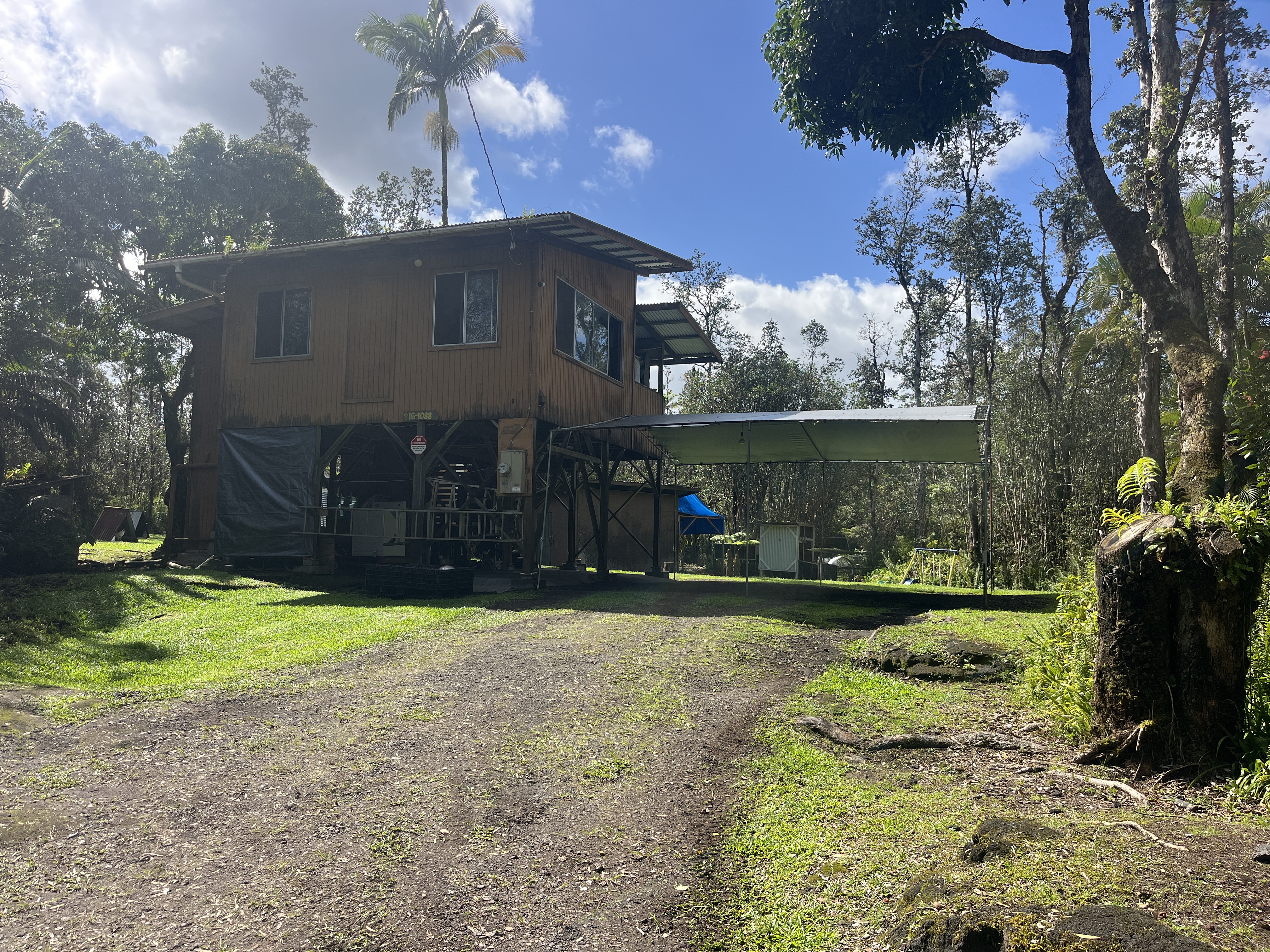 16-1088 Opeapea Road Kurtistown, HI 96760 - Photo 17 of 29 a front view of a house with a yard and garage