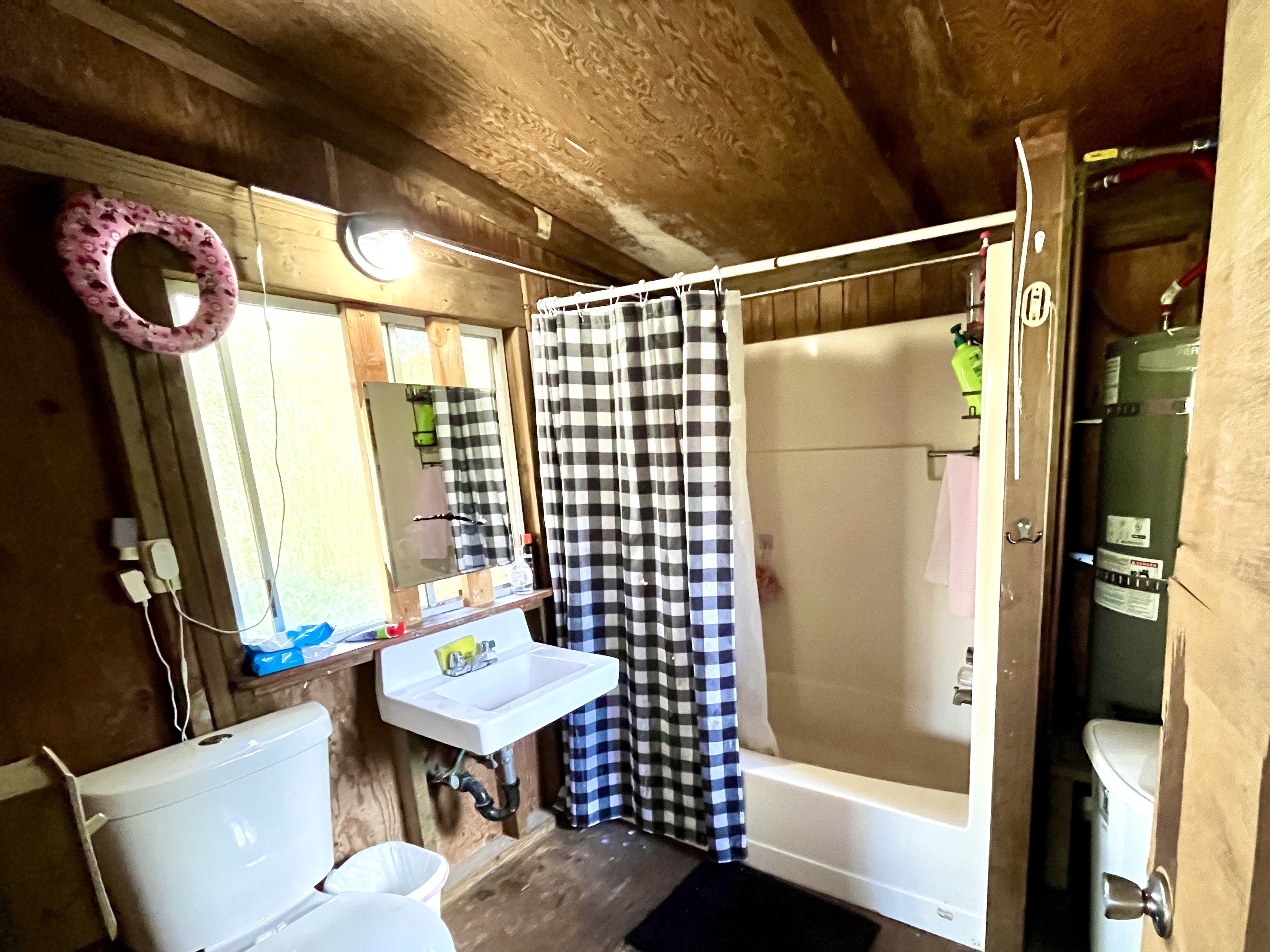 16-1088 Opeapea Road Kurtistown, HI 96760 - Photo 9 of 29 a bathroom with a shower curtain and a sink