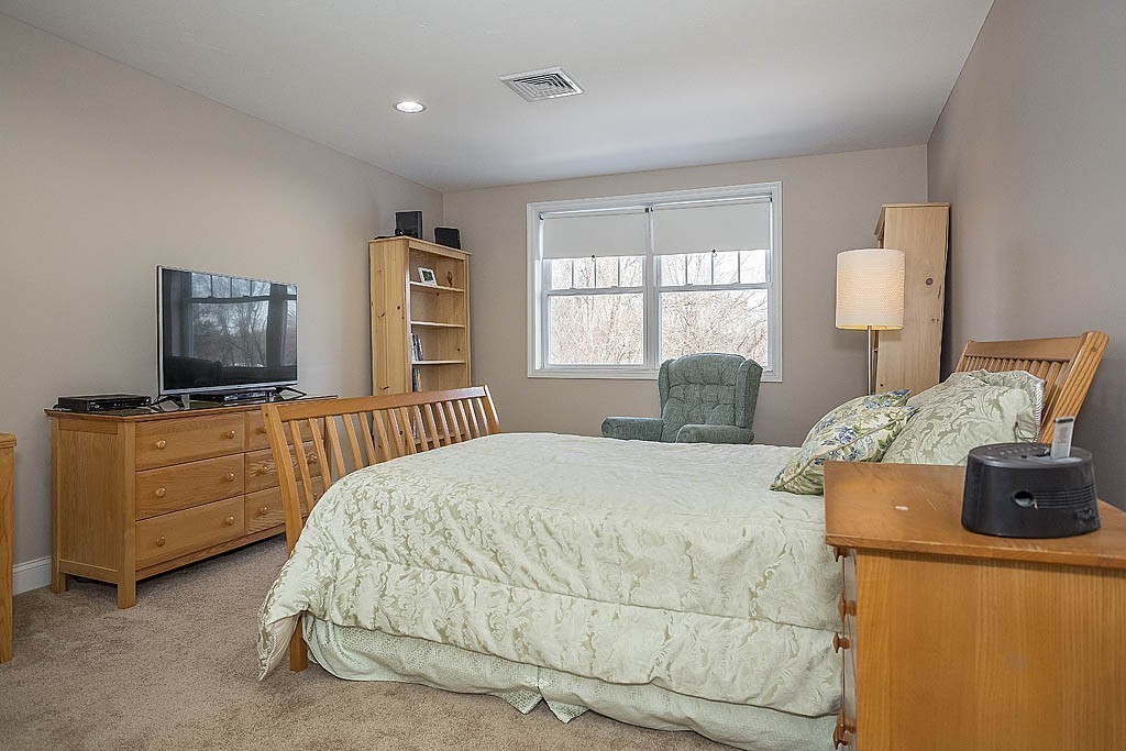 5 Mission Road, Unit 304 Chelmsford, MA 01863 - Photo 12 of 30 a bedroom with a bed and a flat screen television