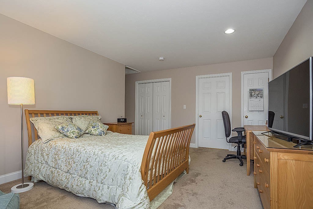5 Mission Road, Unit 304 Chelmsford, MA 01863 - Photo 13 of 30 a bedroom with a bed and a flat screen tv