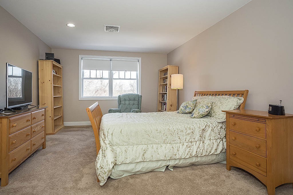 5 Mission Road, Unit 304 Chelmsford, MA 01863 - Photo 14 of 30 a bedroom with a bed and furniture