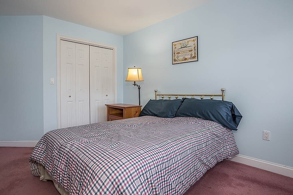 5 Mission Road, Unit 304 Chelmsford, MA 01863 - Photo 18 of 30 a bedroom with a bed and painting on the wall