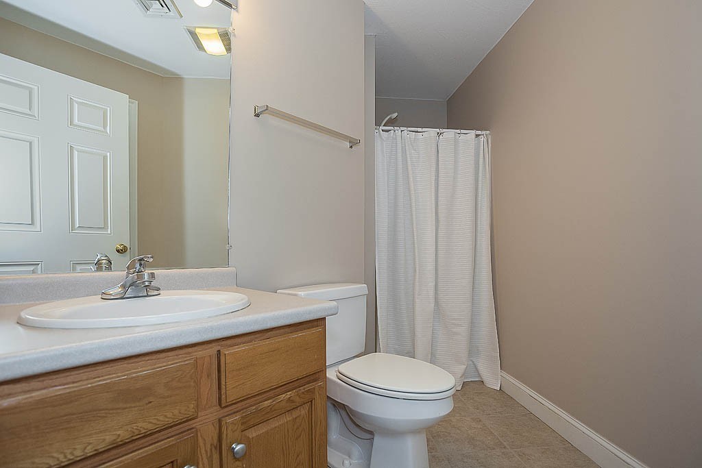 5 Mission Road, Unit 304 Chelmsford, MA 01863 - Photo 19 of 30 a bathroom with a sink a toilet and shower