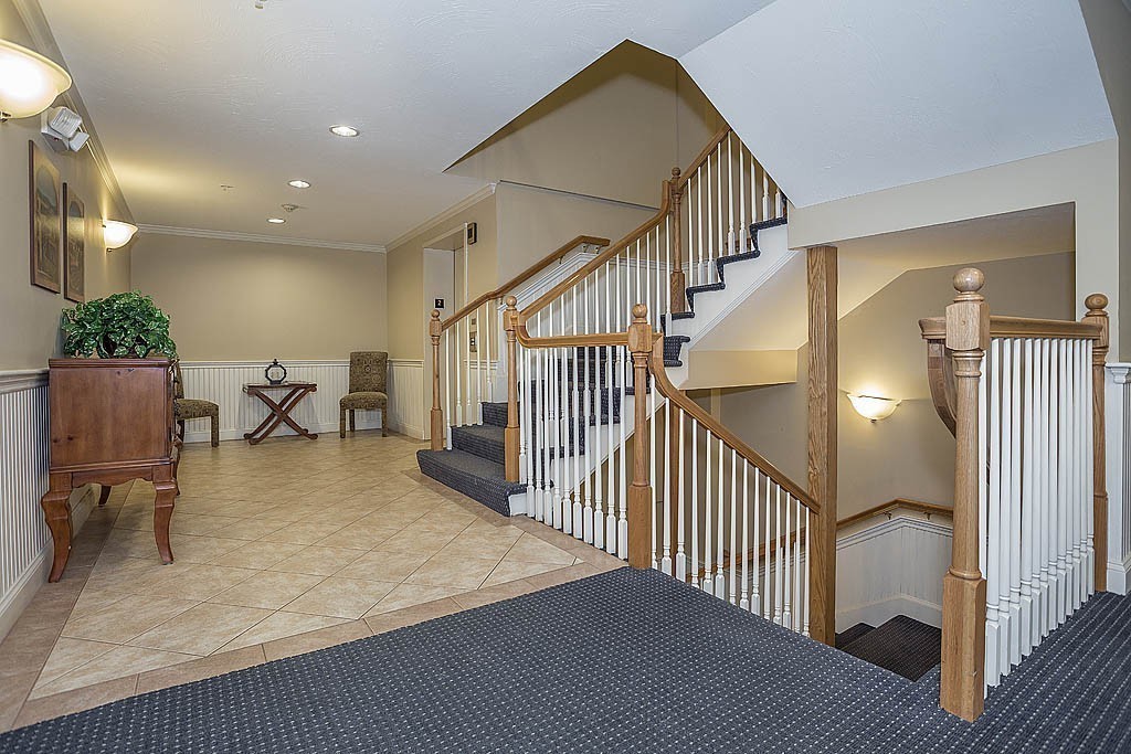 5 Mission Road, Unit 304 Chelmsford, MA 01863 - Photo 21 of 30 a view of a hallway with wooden floor and a dining table