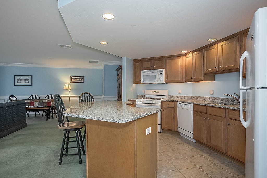 5 Mission Road, Unit 304 Chelmsford, MA 01863 - Photo 4 of 30 a kitchen with stainless steel appliances granite countertop a sink dishwasher a stove refrigerator and cabinets