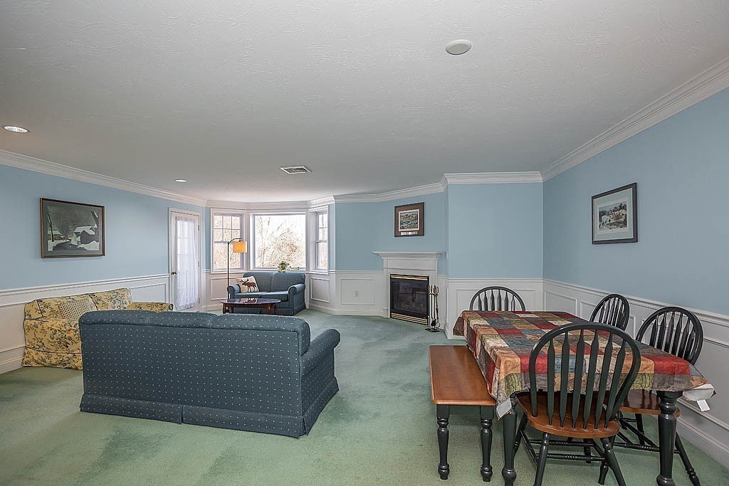 5 Mission Road, Unit 304 Chelmsford, MA 01863 - Photo 7 of 30 a living room with furniture a fireplace and a flat screen tv