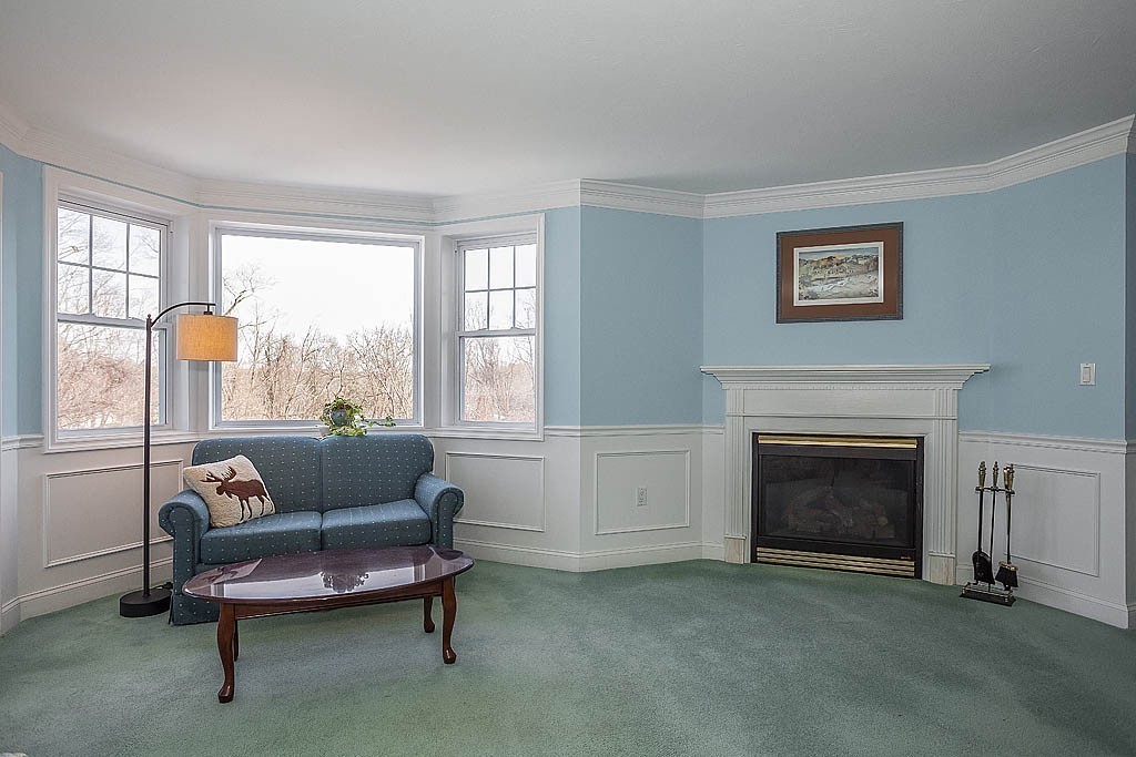 5 Mission Road, Unit 304 Chelmsford, MA 01863 - Photo 8 of 30 a living room with furniture and a fireplace