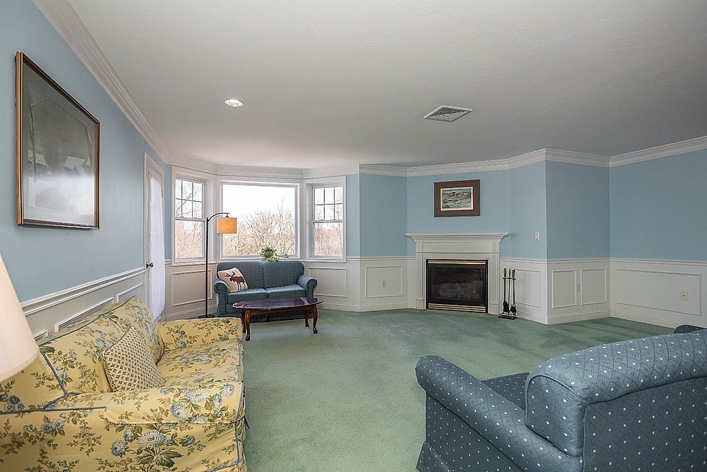5 Mission Road, Unit 304 Chelmsford, MA 01863 - Photo 10 of 30 a living room with furniture and a fireplace