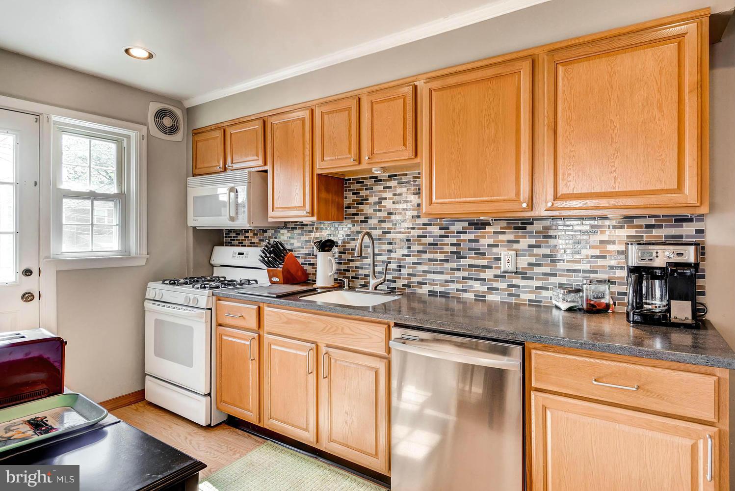 1615 Hardwick Road Towson, MD 21286 - Photo 14 of 30 a kitchen with stainless steel appliances granite countertop a sink stove and cabinets