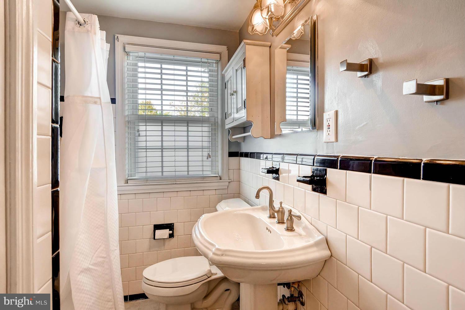 1615 Hardwick Road Towson, MD 21286 - Photo 18 of 30 a bathroom with a sink a toilet and shower curtain