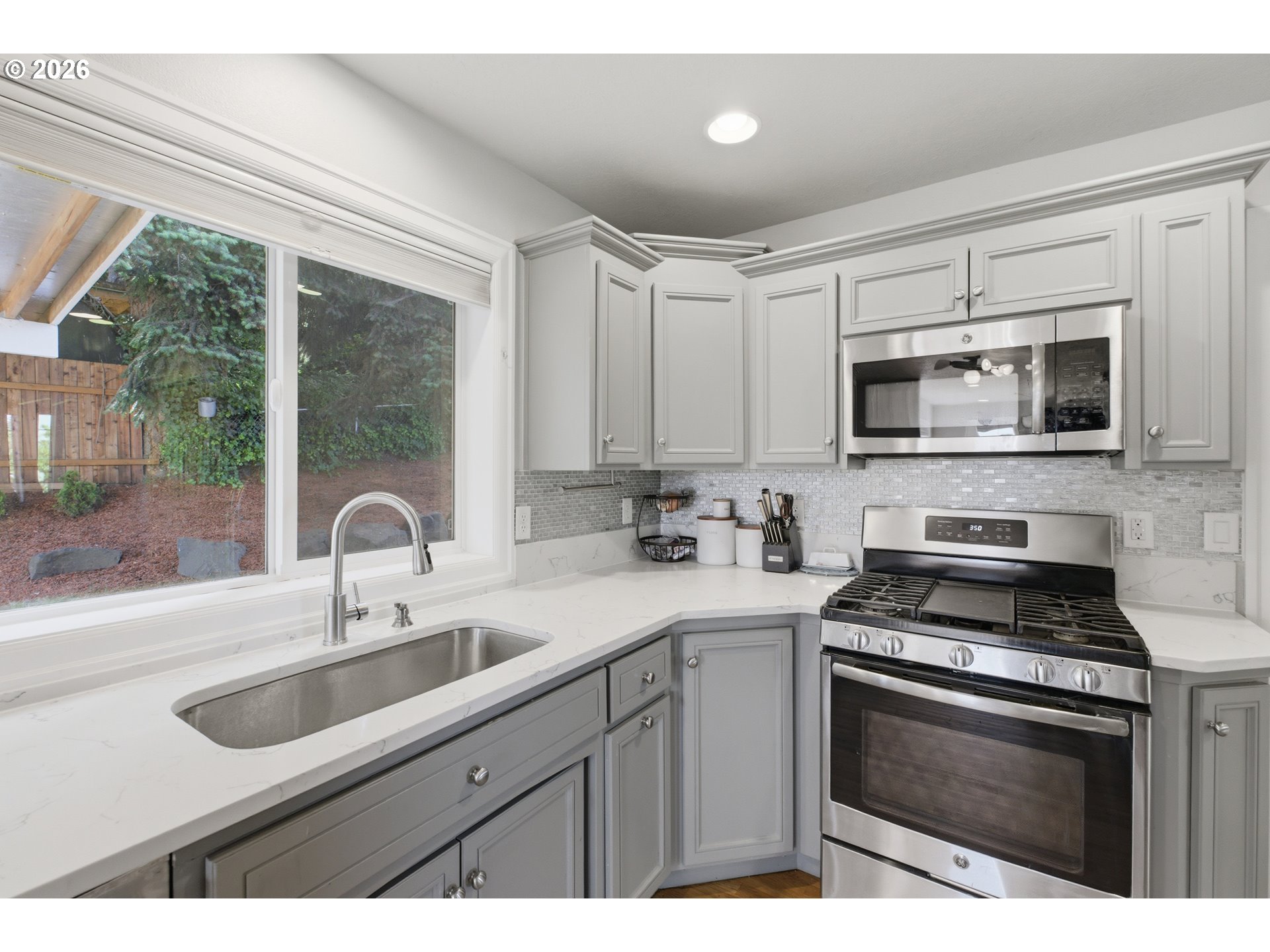 2925 Doaks Ferry Road Northwest Salem, OR 97304 - Photo 19 of 47 a kitchen with sink a microwave a stove and cabinets
