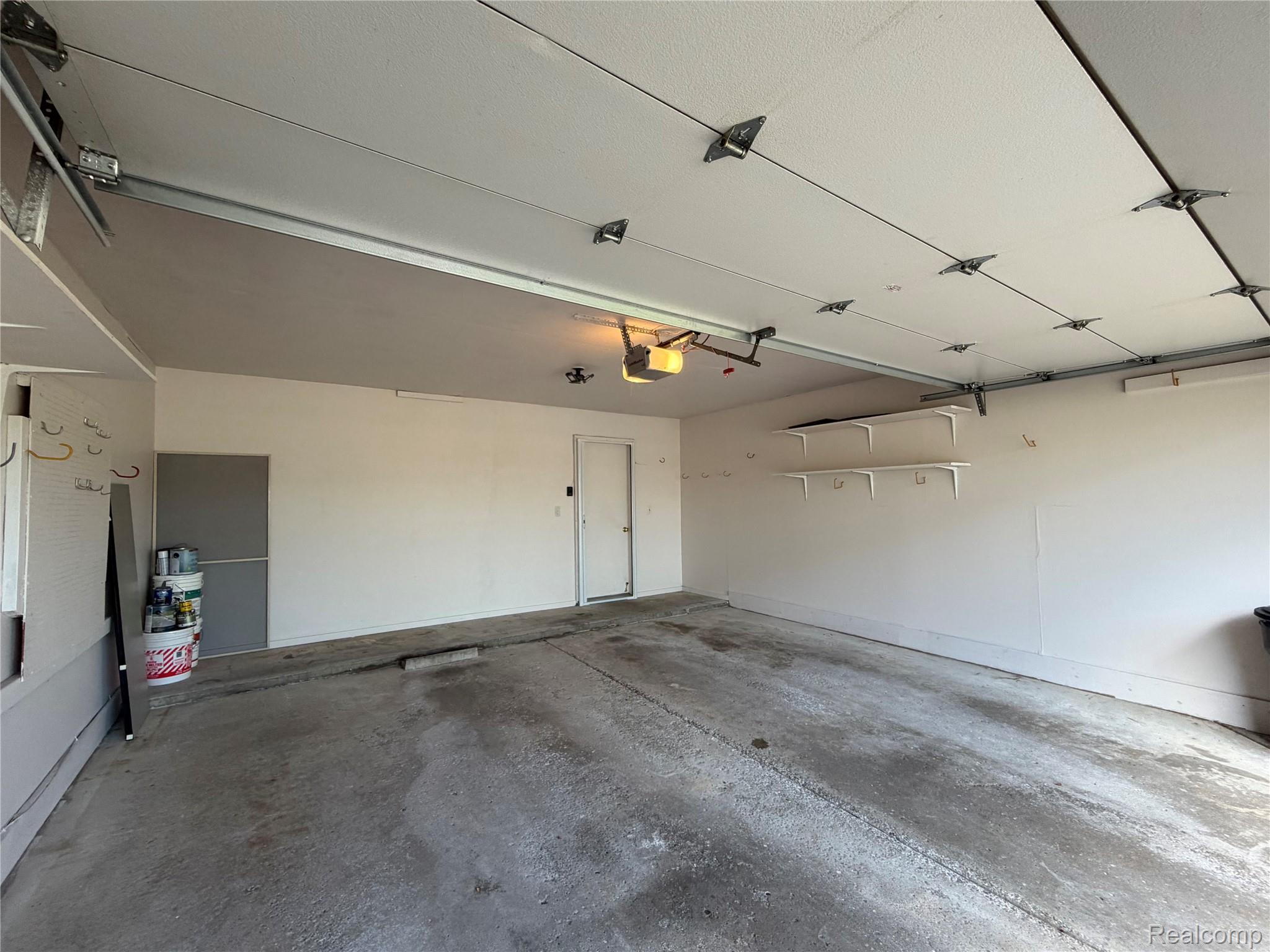 5220 West Utica Road Utica, MI 48317 - Photo 24 of 24 Spacious garage featuring a concrete floor, painted walls, and built-in shelving