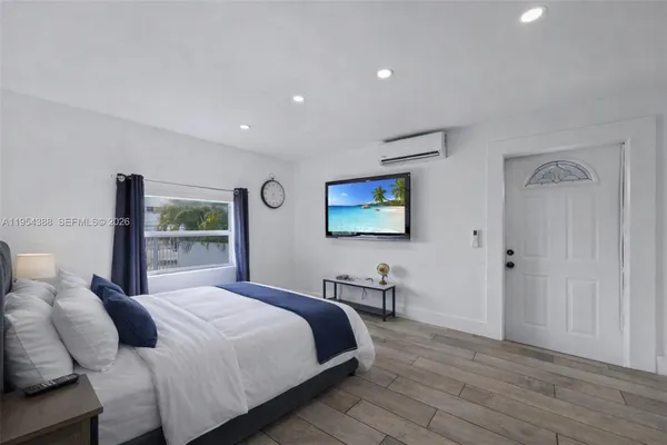 a bedroom with a bed and a flat screen tv
