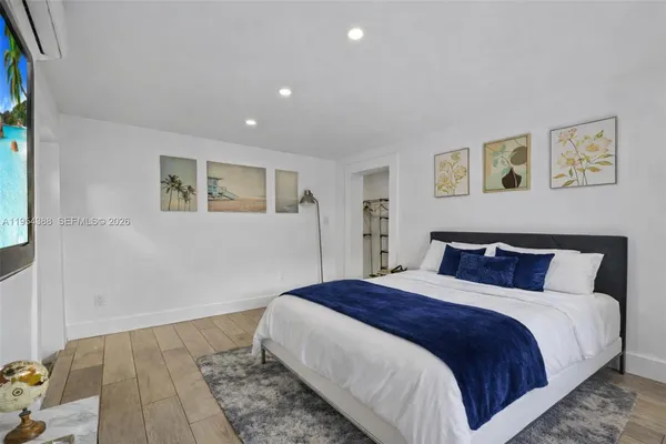 a bedroom with bed and night stand