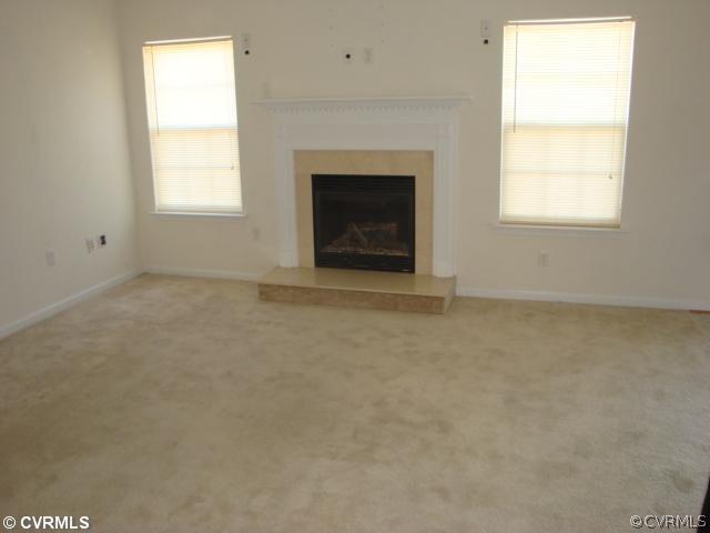5506 Willow Grove Road Chesterfield, VA 23832 - Photo 4 of 9 an empty room with a fireplace and windows