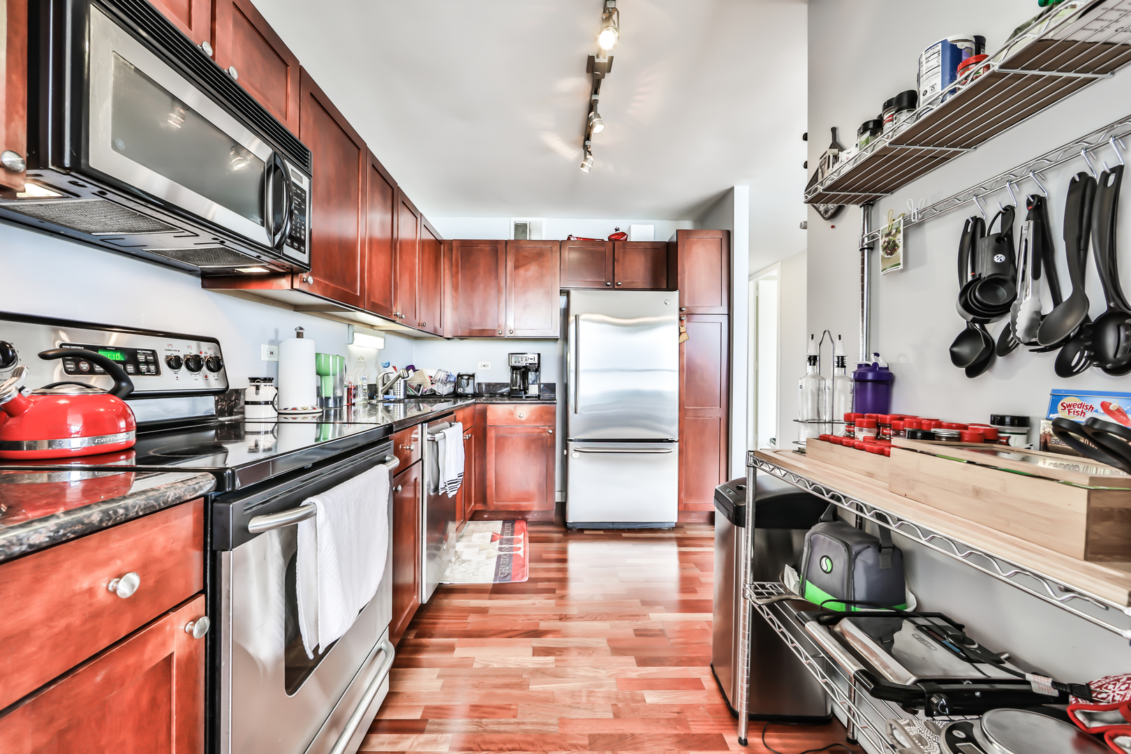 655 West Irving Park Road, Unit 3810 Chicago, IL 60613 - Photo 13 of 26 a kitchen with stainless steel appliances granite countertop a sink stove and refrigerator