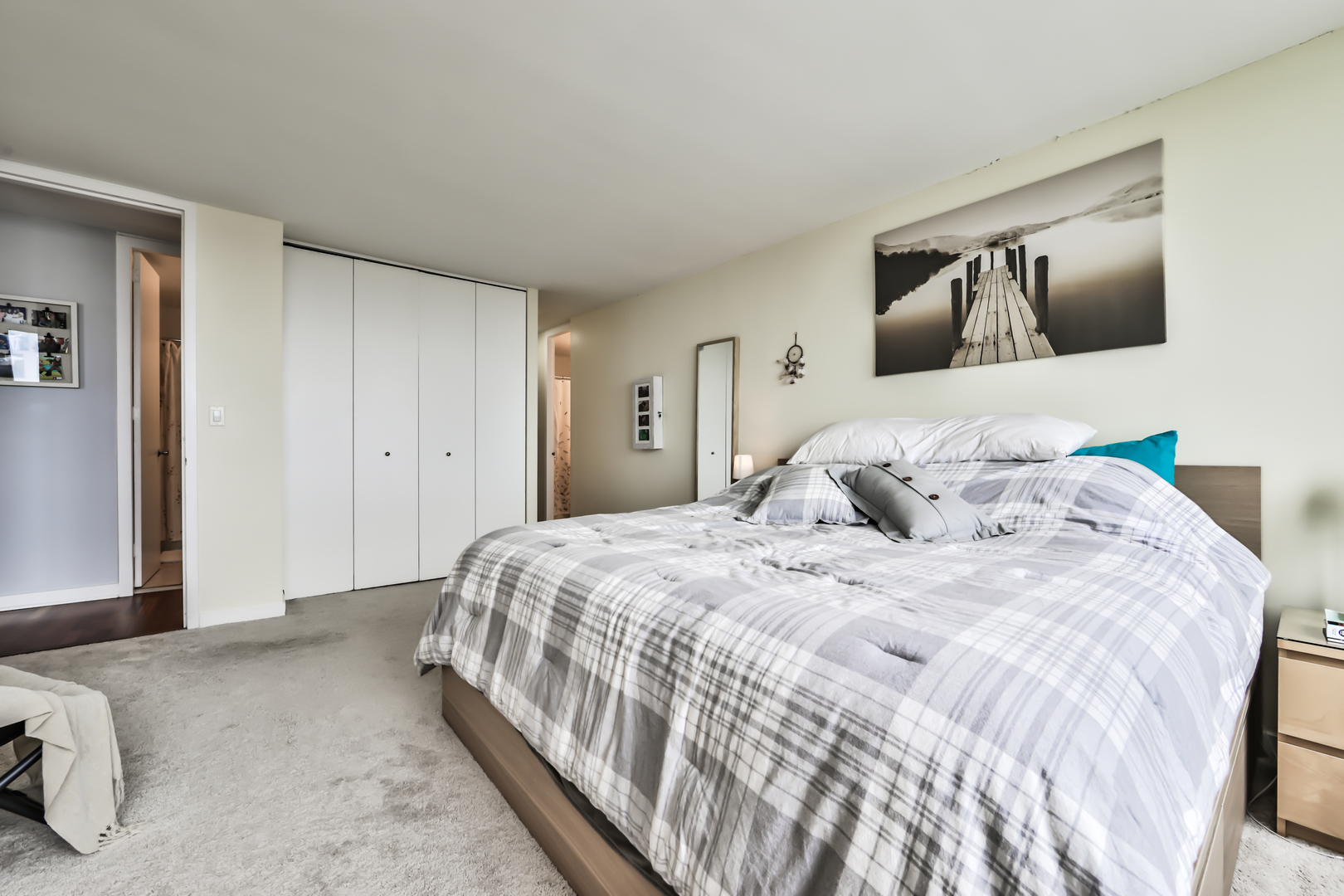 655 West Irving Park Road, Unit 3810 Chicago, IL 60613 - Photo 18 of 26 a bedroom with a large bed and a painting