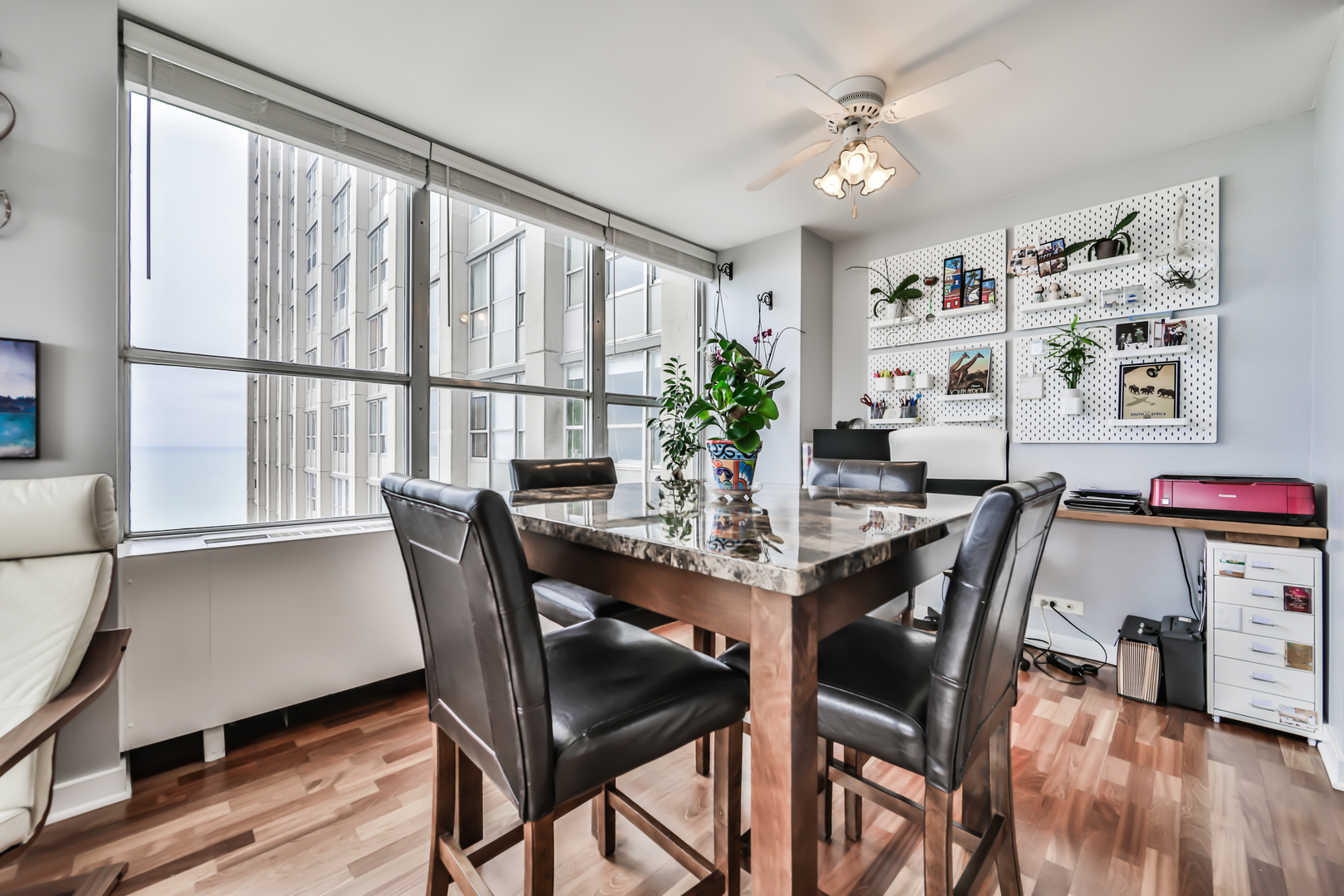 655 West Irving Park Road, Unit 3810 Chicago, IL 60613 - Photo 8 of 26 a view of a dining room with furniture window and wooden floor