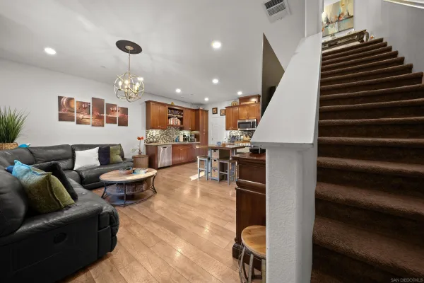 a living room with furniture kitchen view and a fireplace