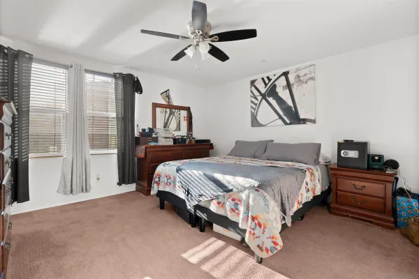 a bedroom with a bed couch and window