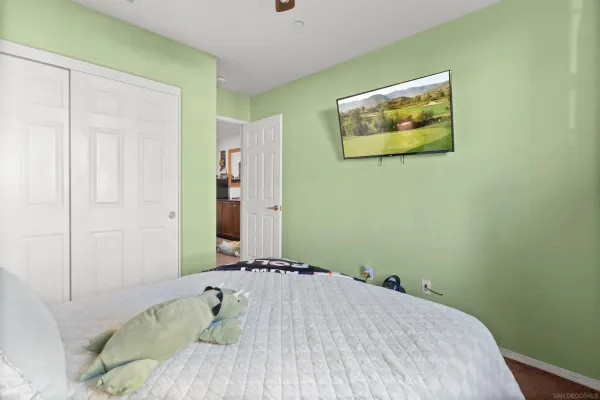 a bedroom with a bed and a painting on the wall