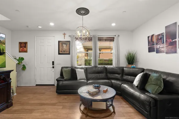 a living room with furniture a window and a chandelier