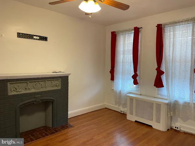an entryway with a fireplace and wooden floor