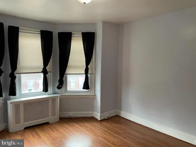an entryway with wooden floor and cabinet