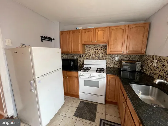 a kitchen with a refrigerator sink and stove