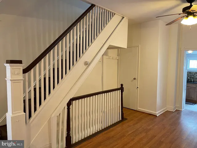 a view of staircase with railing and white walls